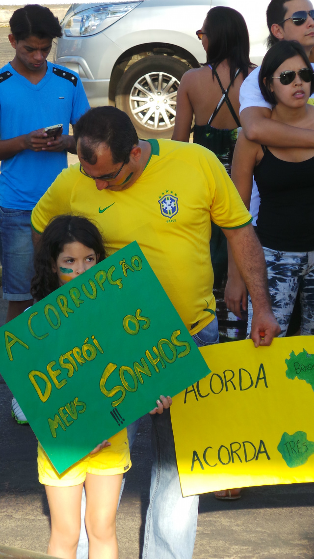 Criança carrega cartaz com frase de protesto com a atual politica do governo brasileiro (Foto: Ricardo Ojeda)