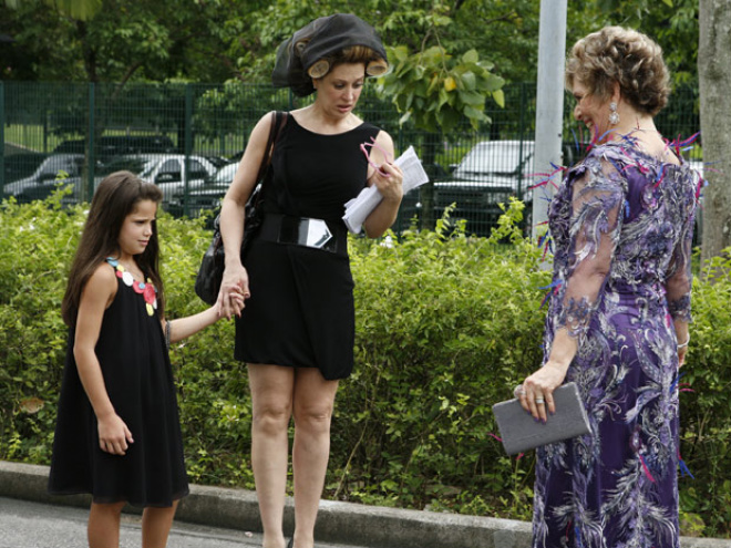 Completamente empolgada e mais uma vez usando um de seus extravagantes modelitos, Clô acaba chamando a atenção de Claudia Raia e de sua filha, Sofia, que só querem entender quem é a fã tão exaltada (Foto: Felipe Monteiro / TV Globo)
