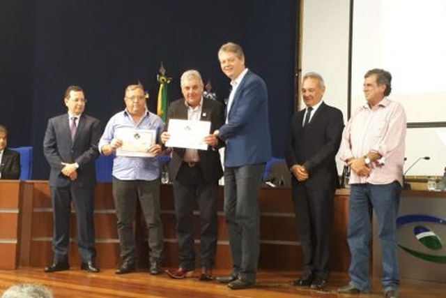 Prefeito recebendo prêmio das mãos do Secretário de Estado de Meio Ambiente , Desenvolvimento Econômico, Produção e Agricultura Familiar, Jaime Elias Verruck