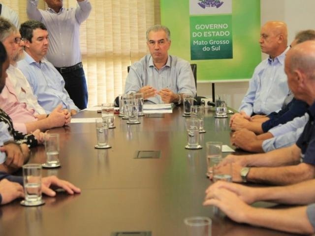 Governador Reinaldo Azambuja (centro) durante anúncio do 13° salário com a participação de secretários e representantes do setor comercial (Foto: Marina Pacheco)
