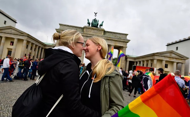 Mulheres se abraçam em manifestação em frente ao Portão de Brandenburg, em Berlim, nesta sexta-feira (30) (Foto: Tobias Schwarz / AFP)