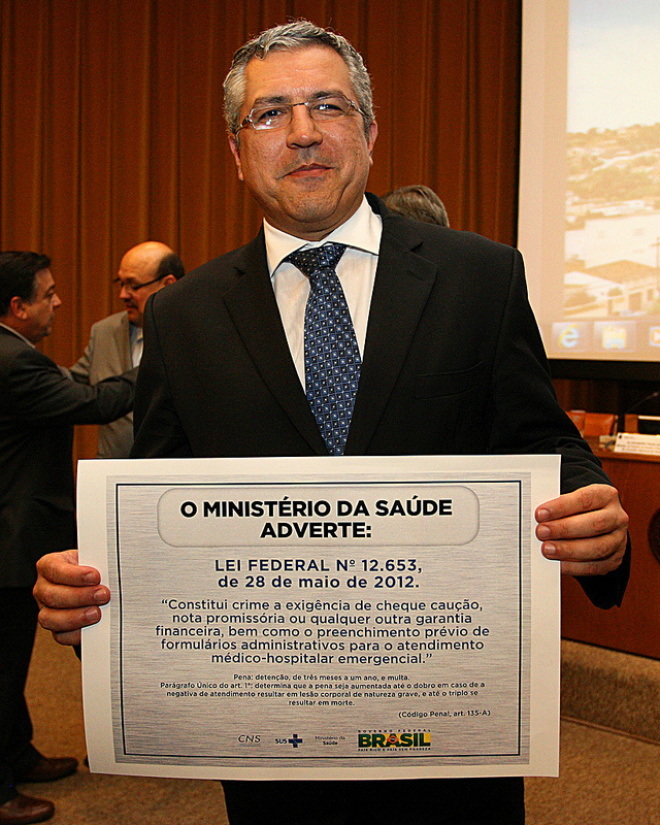 Hospitais privados terão de exibir cartaz com direito do paciente Ministro da Saúde posa com cartaz (Foto: Divulgação)