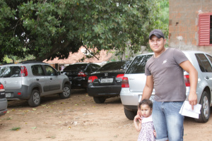 O morador, Eloi Feliciano Martins da Silva, 24 anos, faturou R$ 90 reais explorando o quintal da sua casa como estacionamento (Foto: Ricardo Ojeda) 