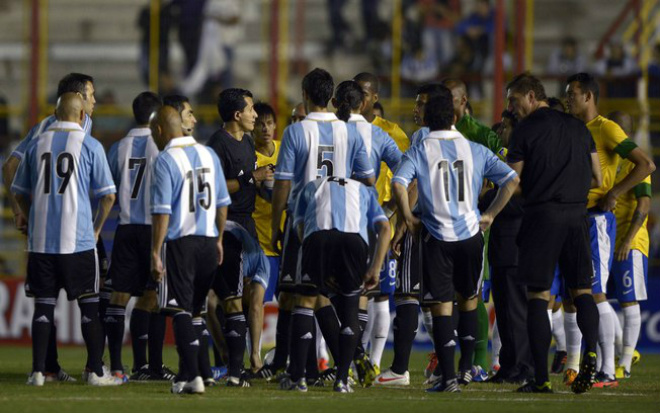 Jogadores conversam com o árbitro após a queda de energia (Foto: AFP)