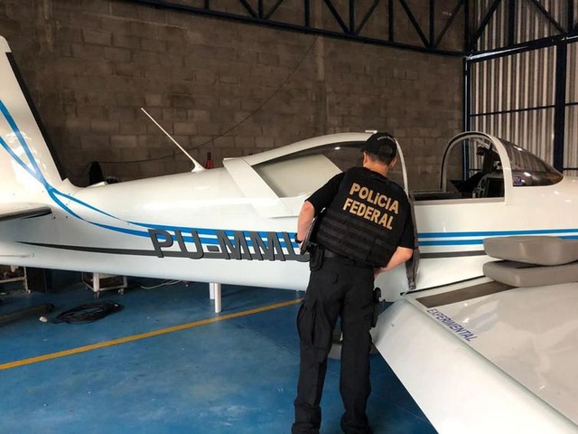 PF deflagra ação para desarticular organização internacional de drogas Policial observa aeronave apreendida durante operação Flak (Polícia Federal/divulgação)