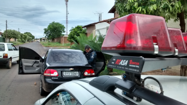 Policial militar vistoria o automóvel, abandonado com as portas abertas em frente a Unei de Três Lagoas (Foto: Celso Daniel/Perfil News)